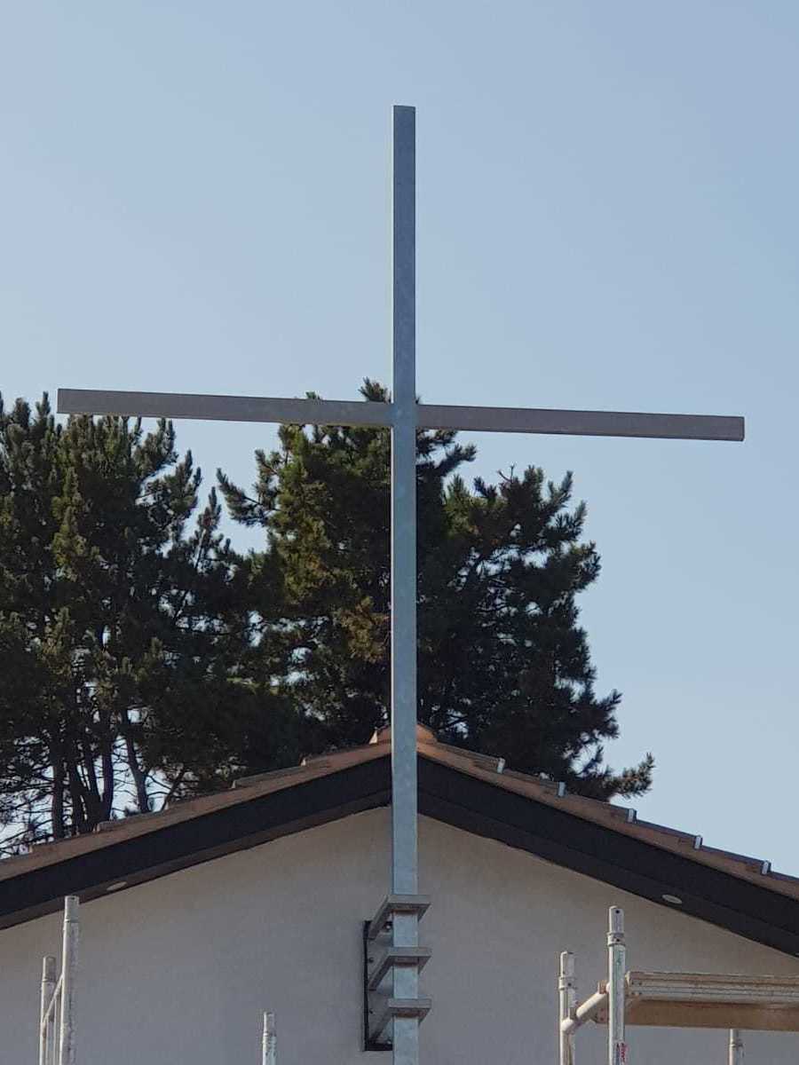 Stainless steel cross on a church in Coventry. Manufactured and installed by Eagledale Architectural Metalwork.